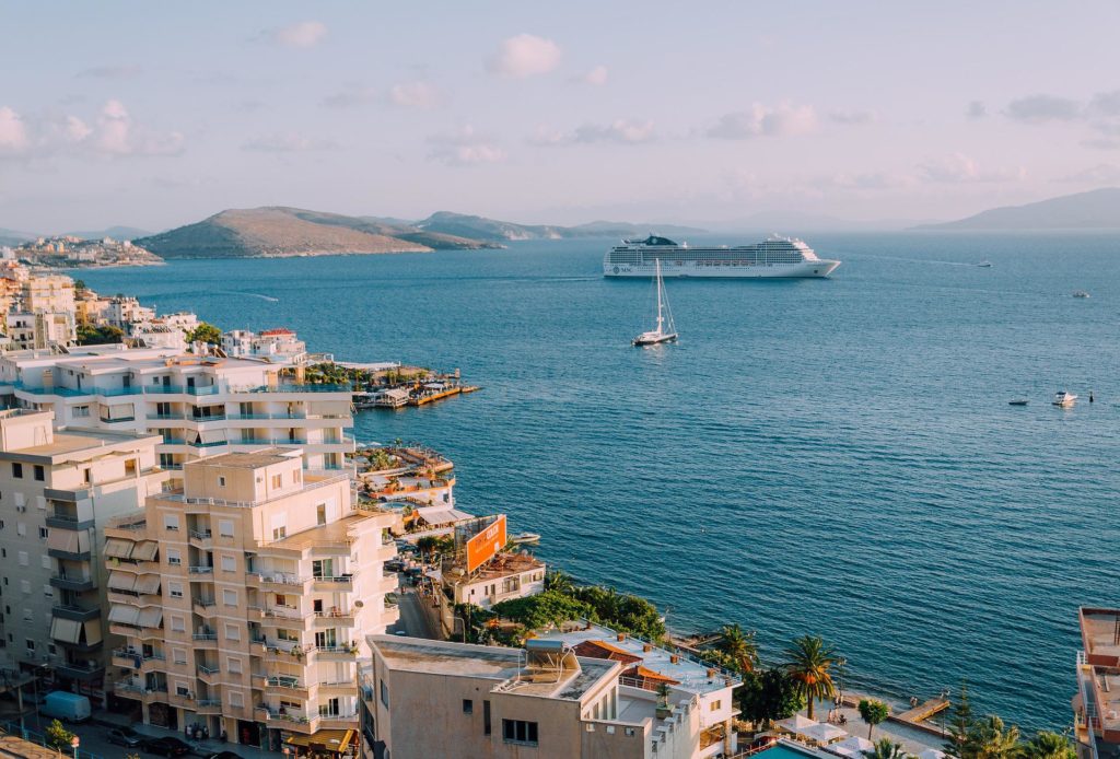 Ship off the port of a European coastal city.