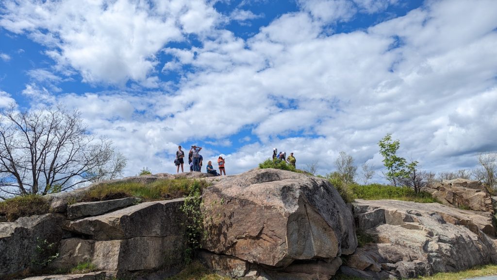 Hikers atop Prospect Mountain enjoy the 100-mile view of the Adirondacks and mountains in New York, Massachusetts and Vermont.