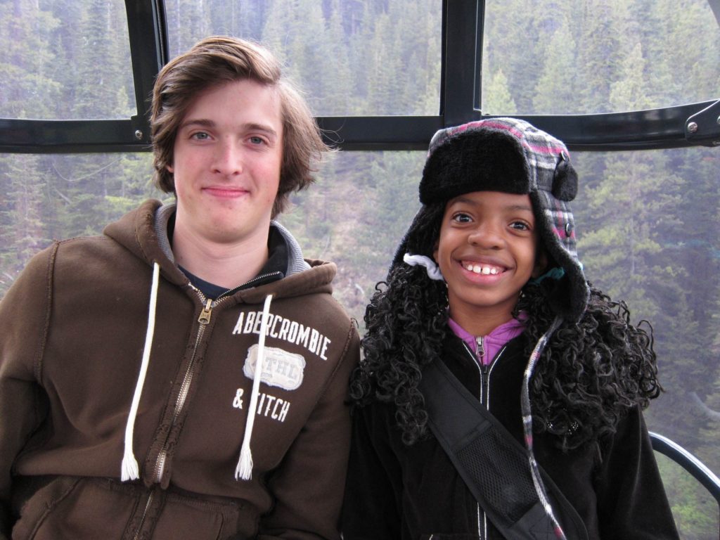 Boy and girl sit on gondola
