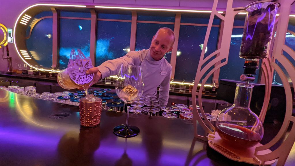 Bartender works on outerspace beverages in the Star Wars Hyperspace Lounge on the Disney Wish cruise ship.