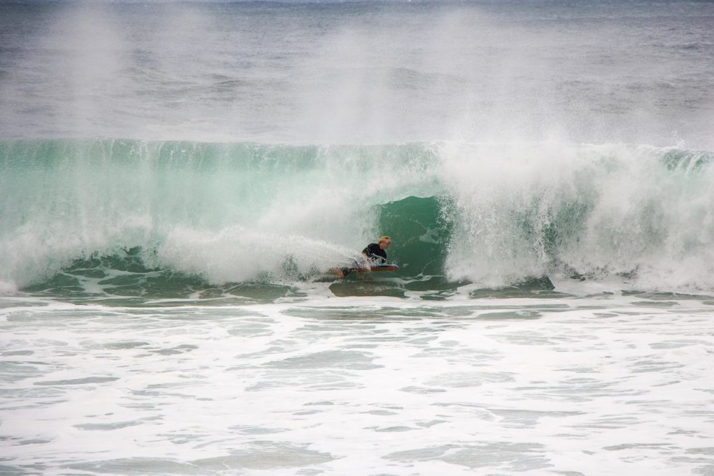 Surfer riding rough waves at Oahu's North Shore.