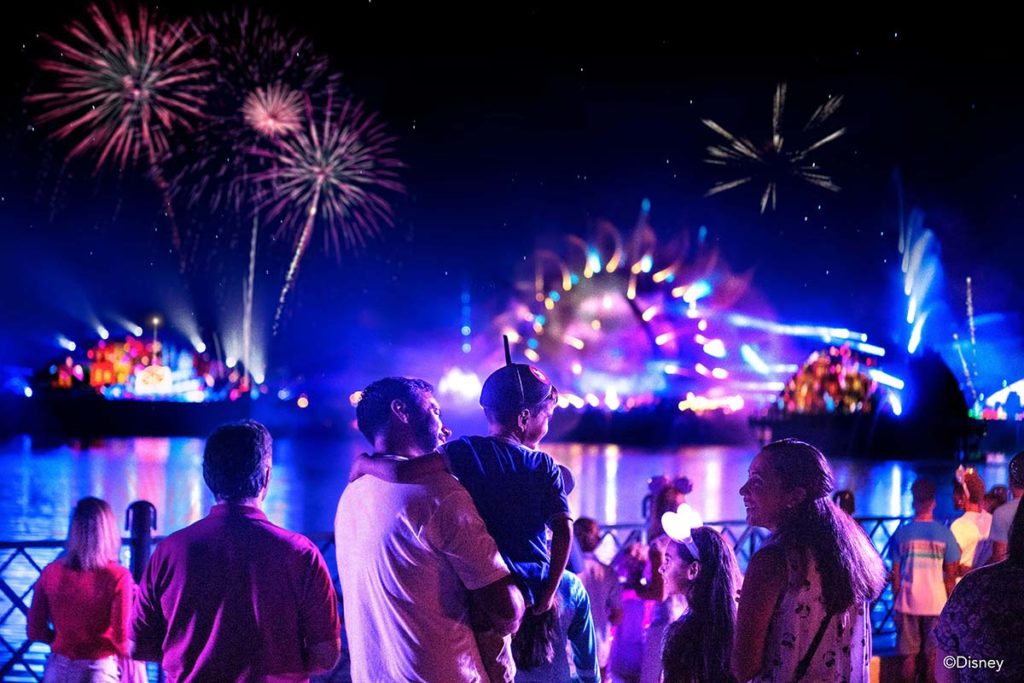 Families watch the spectacular new fireworks shows designed for the Walt Disney World 50th Anniversary. Photo c. Disney