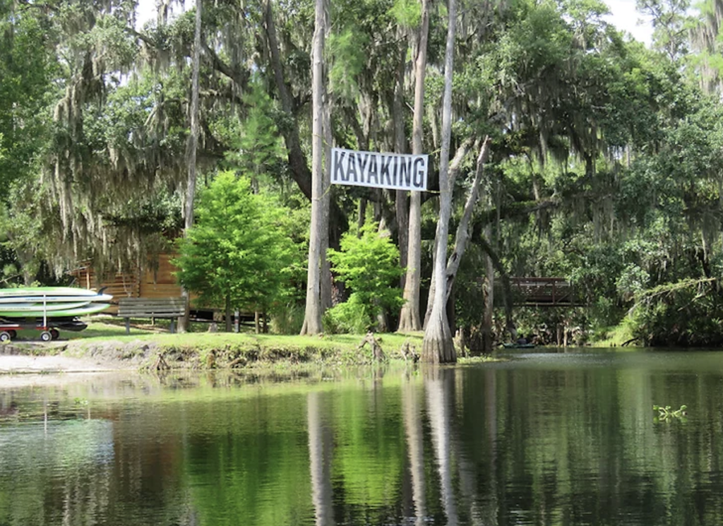 Kayaking sign hangs over the water at Shingle Creek Park, Florida.
