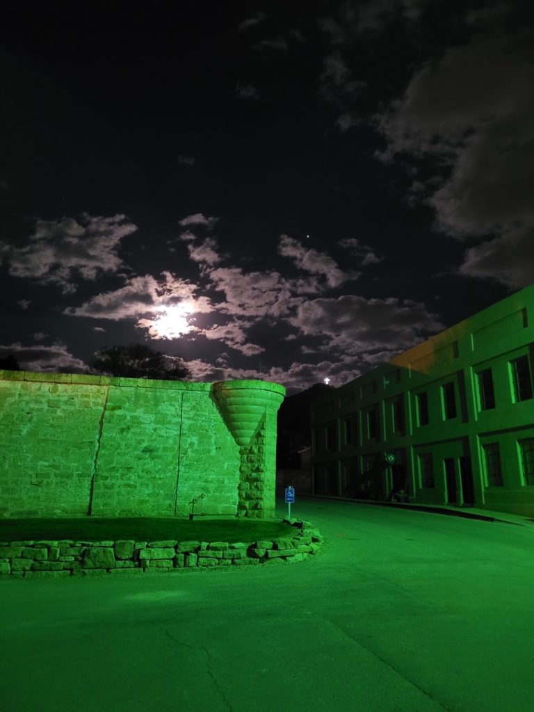 The Old Idaho Penitentiary lit for Halloween dominates the night in Boise, Idaho. Photo c. Visit Idaho.