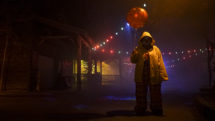 Scary figure in clown outfit and yellow poncho walks with balloon at Scarywood, at Silverwood theme park in Idaho. Photo c. Visit Idaho.