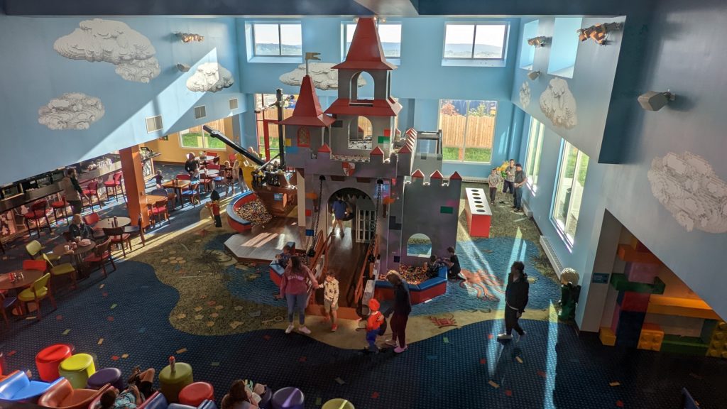 View of the LEGOLAND New York Hotel lobby with LEGO castle and pirate ship stocked with extra LEGO bricks.