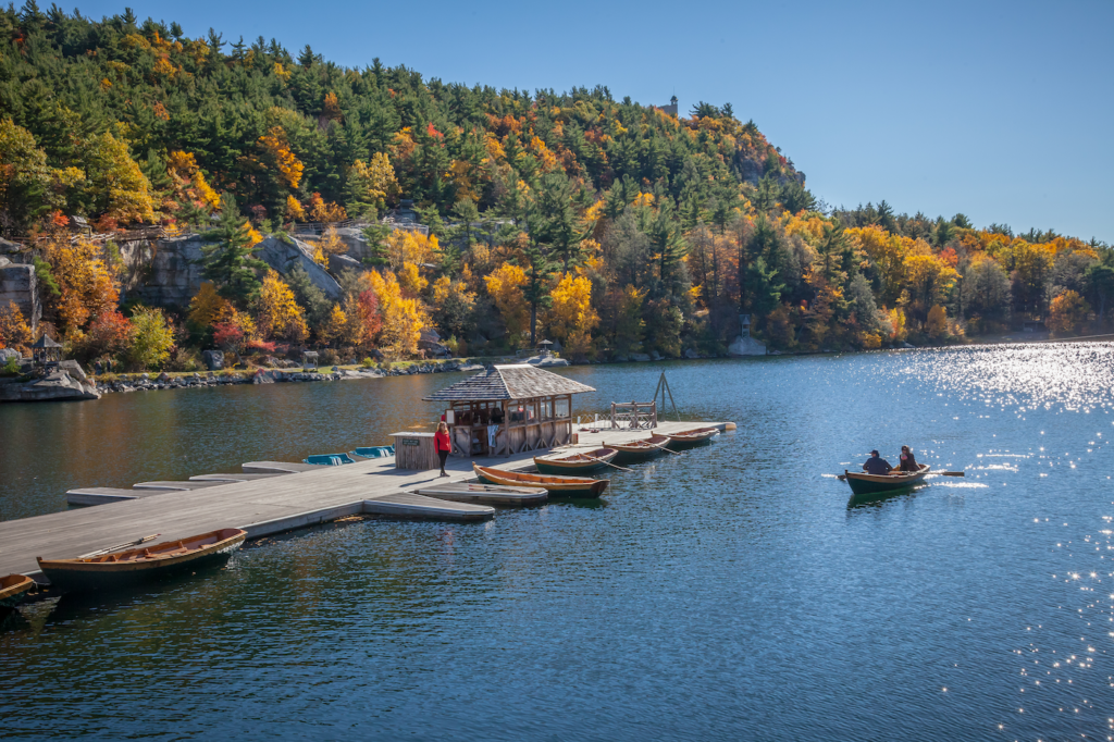 Boat dock at Lake Mohonk with surrounding banks of changing leaves in autumn. Photo c. NY State Division of Tourism - I Love NY