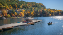 Boat dock at Lake Mohonk with surrounding banks of changing leaves in autumn. Photo c. NY State Division of Tourism - I Love NY