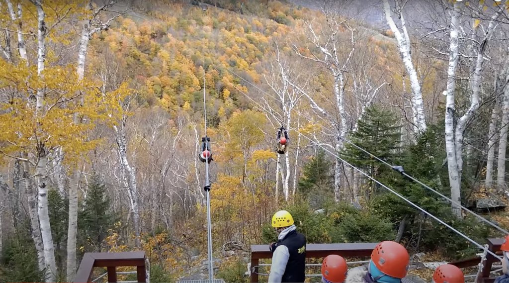 Guests in helmets wait their turn at New York Zipline, near Hunter Mountain, The Catskills, New York