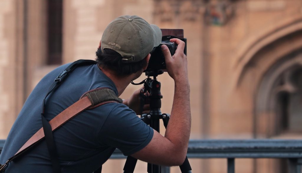 Photographer with tripod takes a picture.