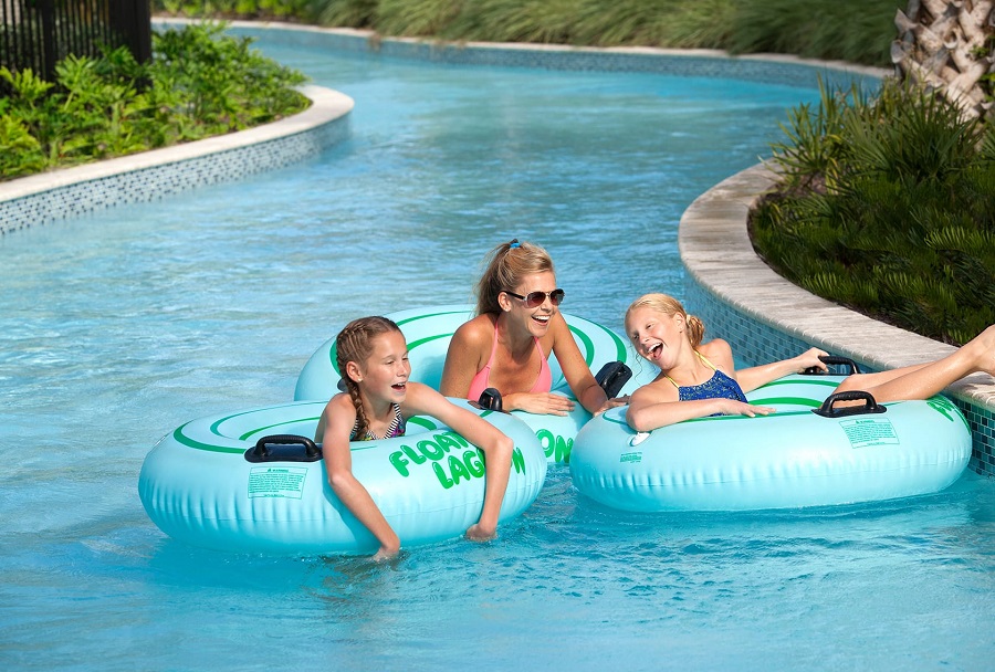 Mom and two kids float along the lazy river at Hilton Lake Buena Vista Palace in Orlando.