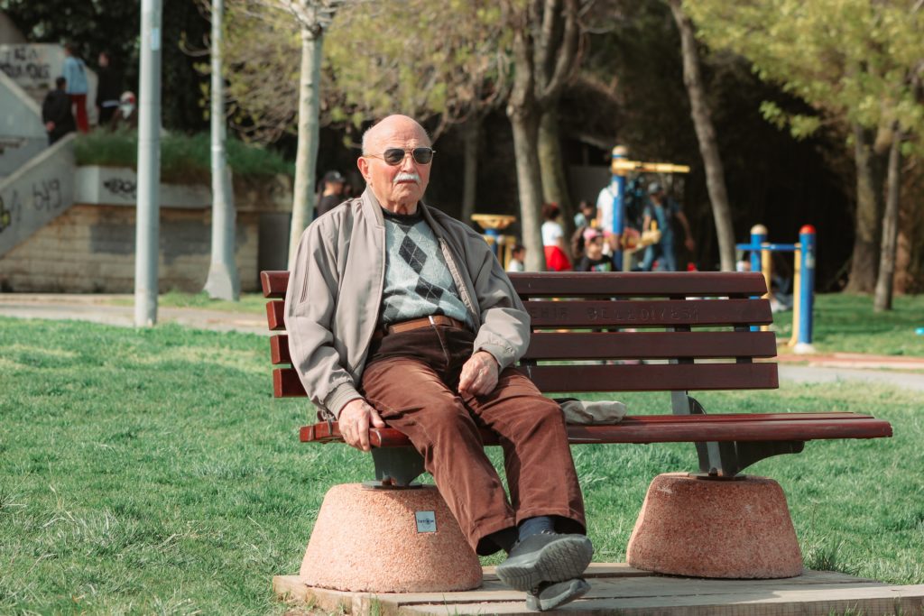 An old man sits on a park bench thinking about the marriage market that takes place in Peoples Park, Shanghai, China.
