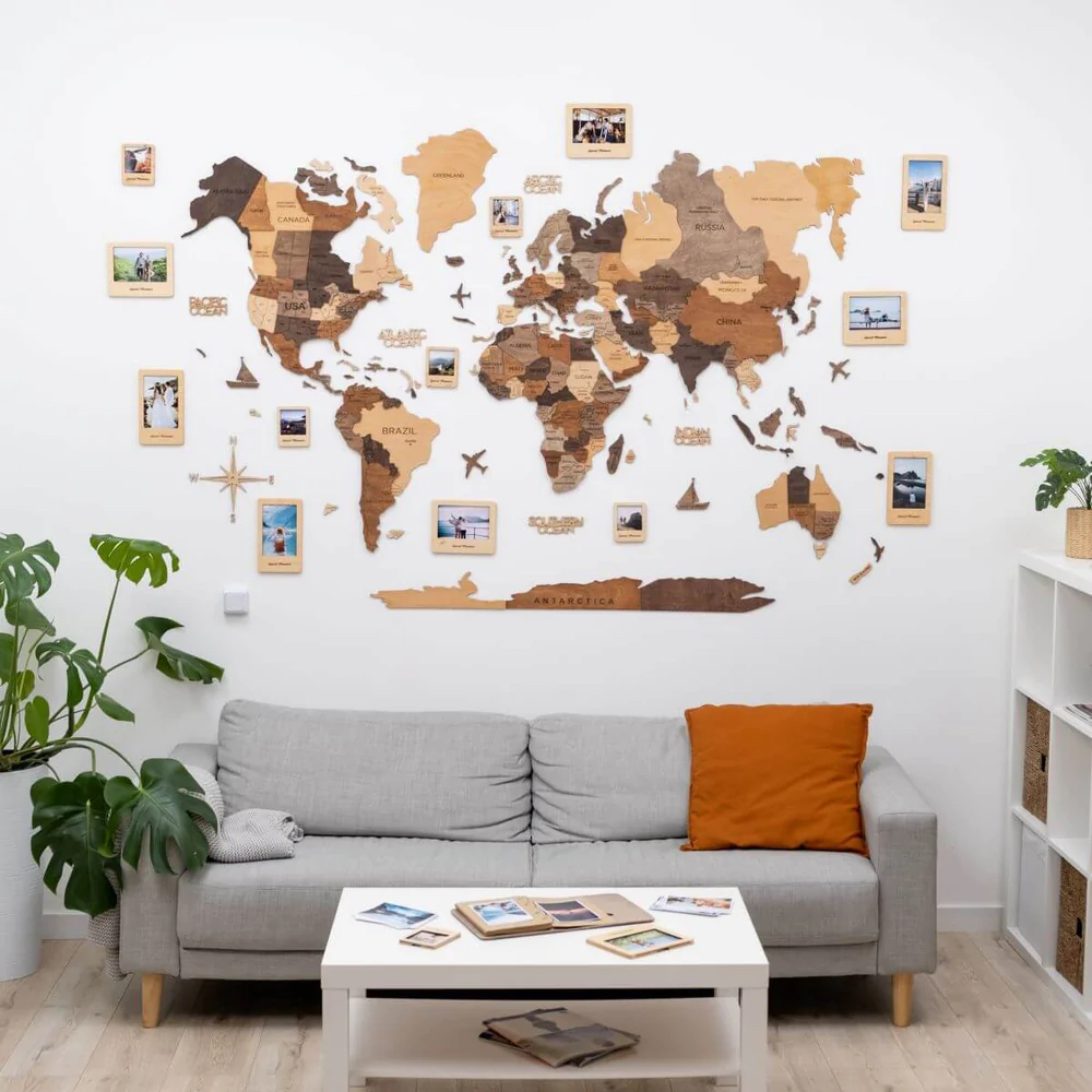 A wall mounted world map made of wooden puzzle pieces hangs in a living room over the couch.