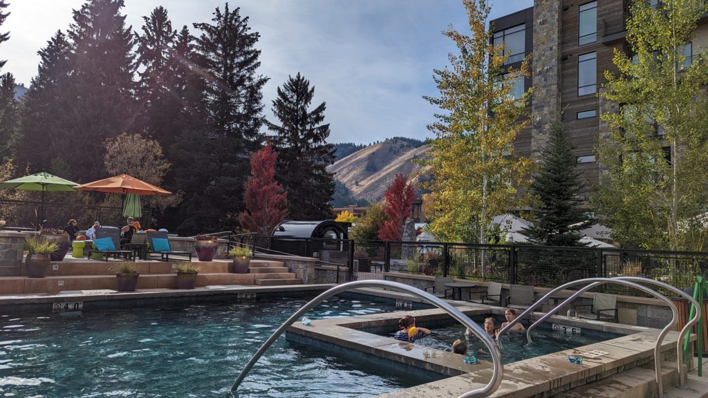 People sunbathe at the pool and hot tub on the mountainview deck of the Limelight Ketchum Hotel in Ketchum Idaho