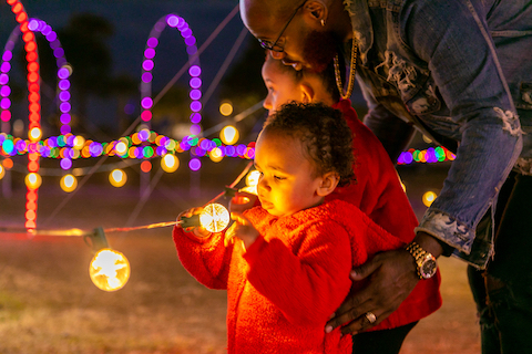 Family studies Christmas lights in Myrtle Beach.