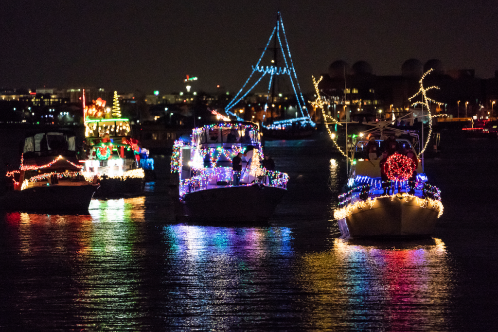 Illuminated boats reflect off the Potomac River during Alexandria Virginia's Holiday Boat Parade of Lights. Photo c. Evan Michio for Visit Alexandria