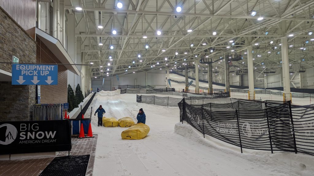 Lift operators groom the snow tubing runs at the Big Snow indoor ski park.