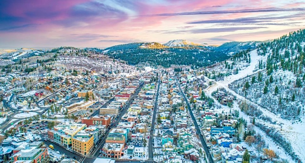 Aerial view of Park City, Utah surrounded by snow-capped mountains in winter.