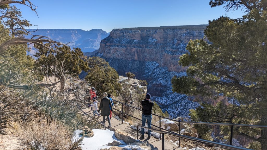 Families walk along the South Rim Trail at Grand Canyon National Park.