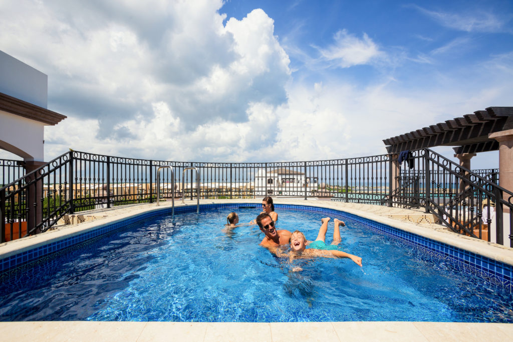 One of the family pools overlooks the beach at Grand Residences Cancun Resort.