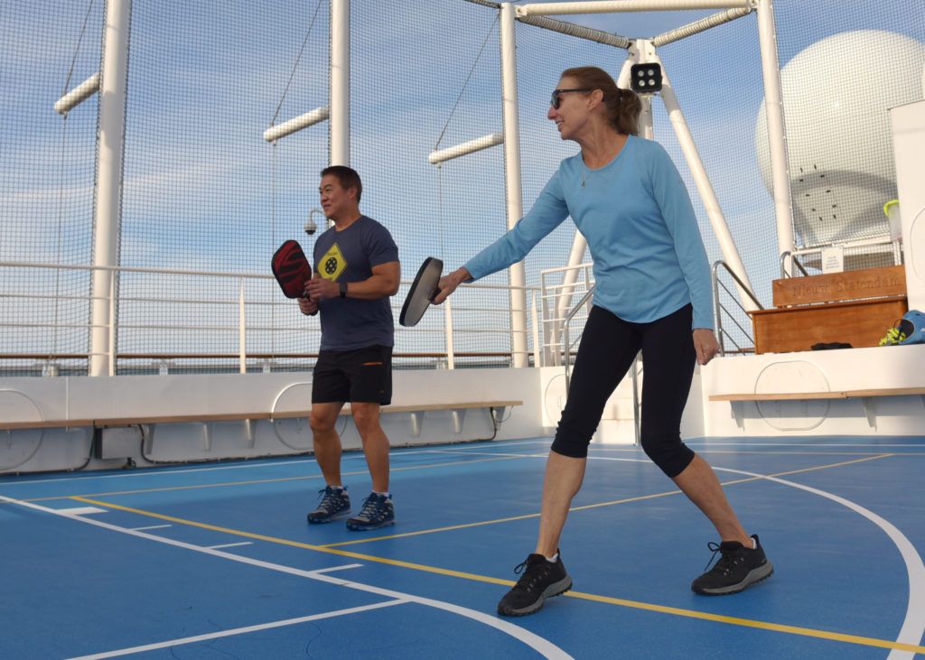Man and woman playing pickleball aboard the Holland America ship Nieuw-Statendam.