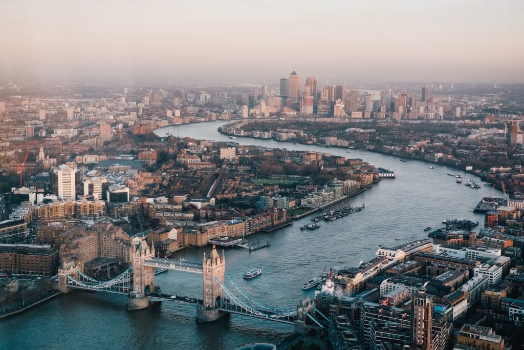 A bird's-eye view of the Tower Bridge and Thames River in the city of London.
