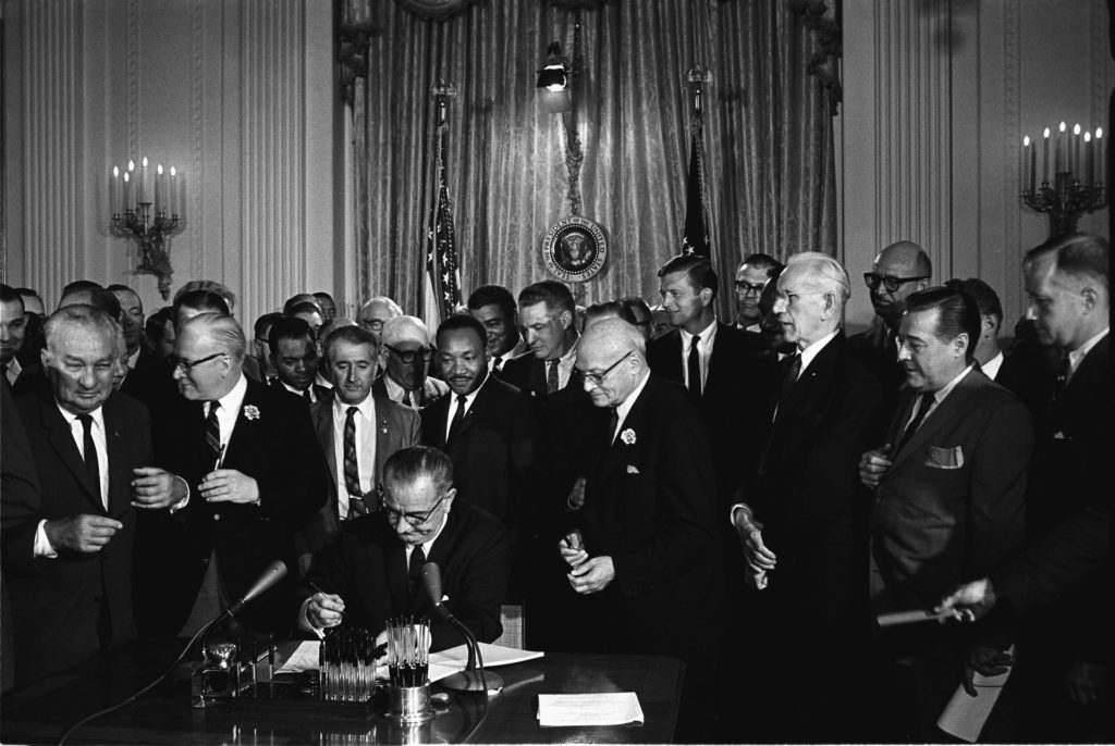 News phoot of President Lyndon Johsnon signing the Civil Rights Act, July 2, 1964. Courtesy WikiImages via pixabay.