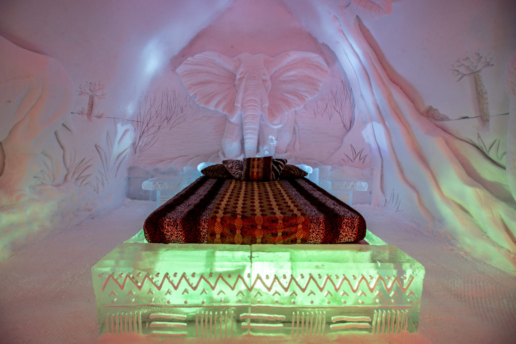 A decorated suite made of ice with a huge elephant headboard is at the Ice Hotel at Valcariter in Quebec. Photo c. Village Vacances Valcartier