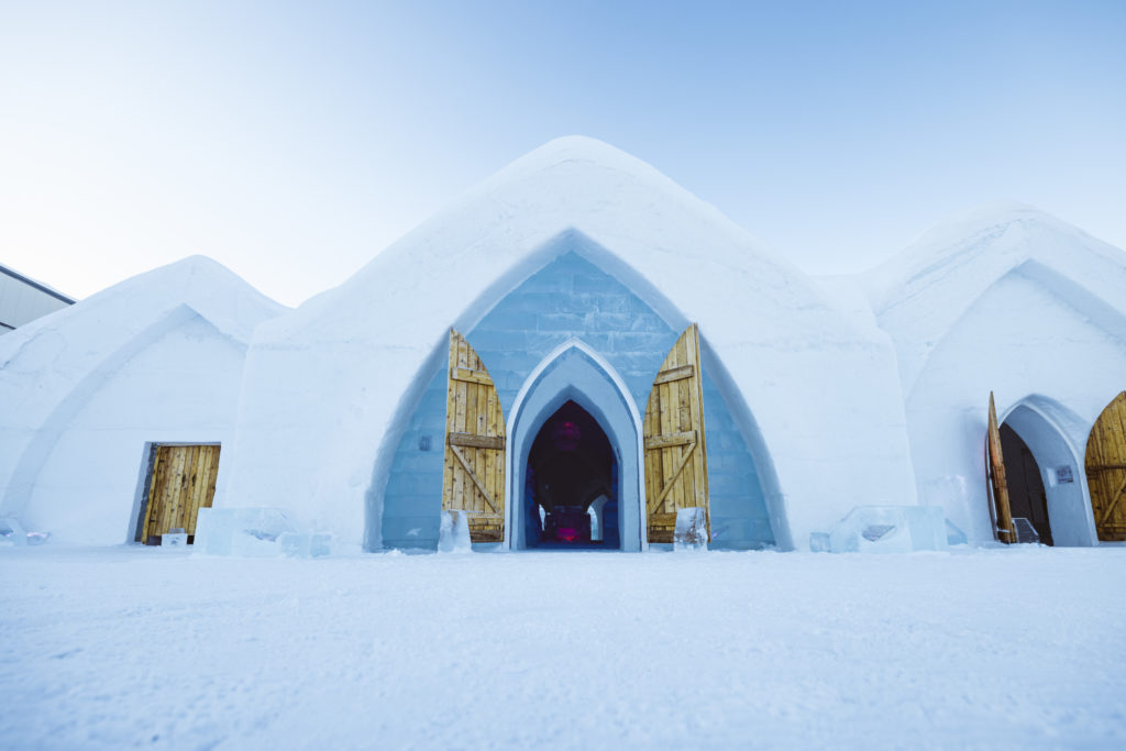 The igloo style facade of the Ice Hotel in Quebec hides the amazingly intricate ice carving within its guestrooms and public areas. Photo c. Village Vacances Valcartier