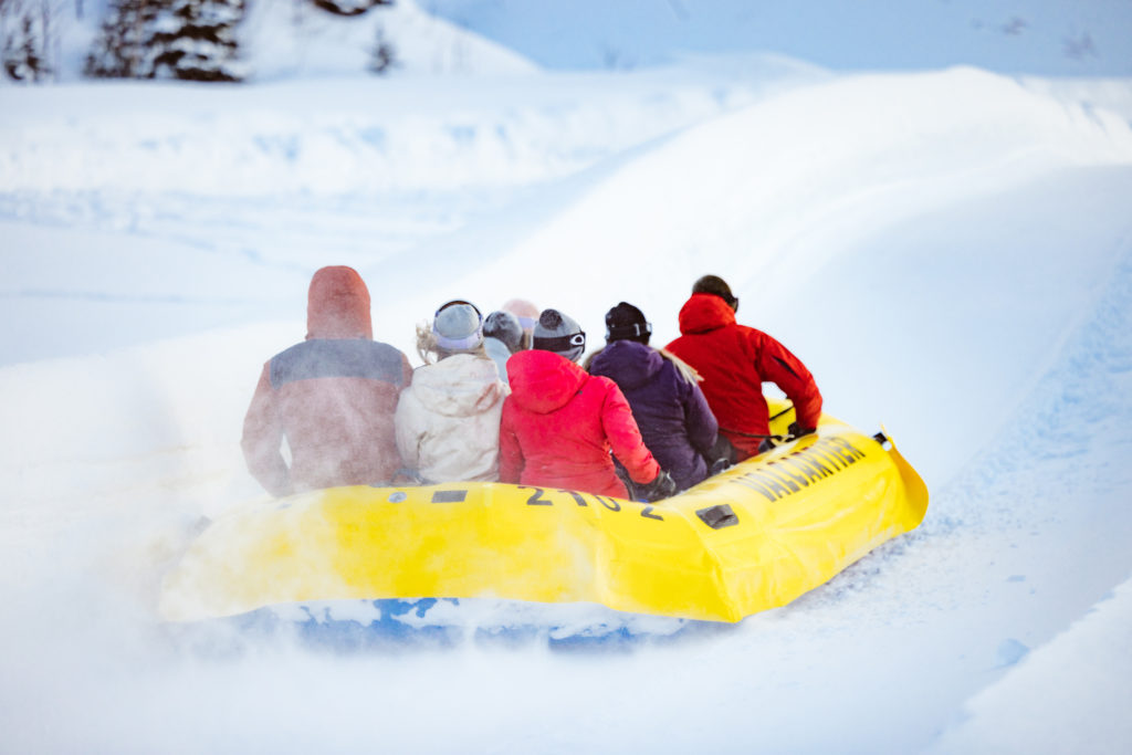 Several people are packed into one large raft for extreme snow tubing at Valcartier's Winter Park.