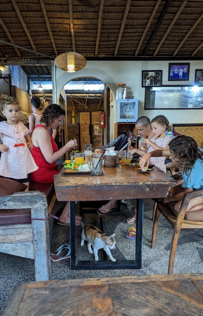 FAmily dines together at casual Besahi Warung in Nyuh Kuning, Bali, Indonesia.