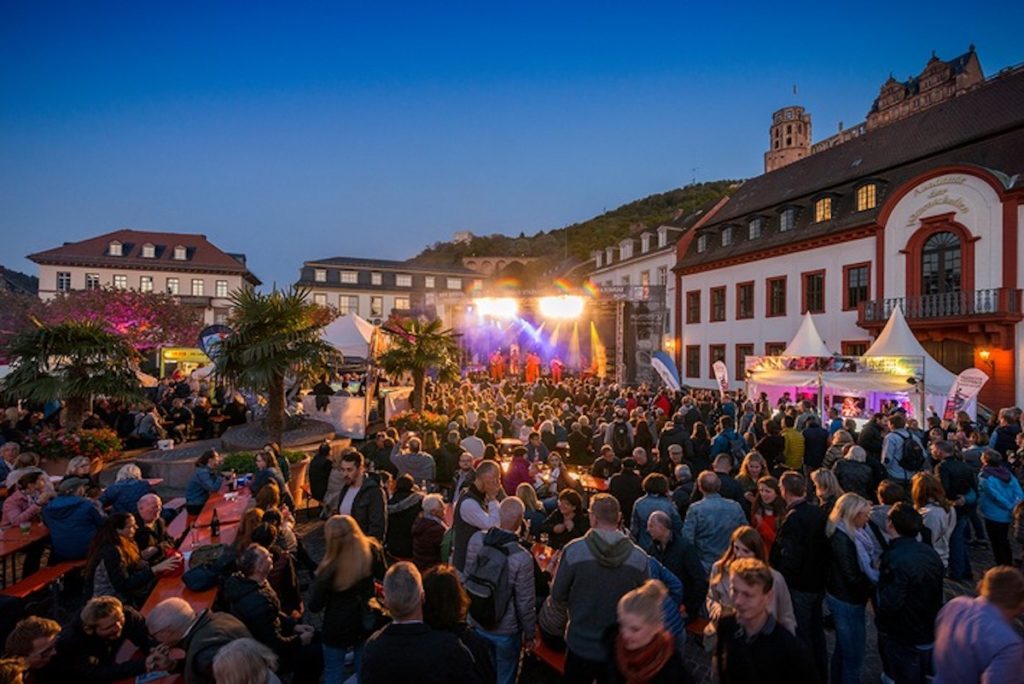 Crowds gather in the town square at dusk for the annual Herbst Festival in Heidelberg. Photo by Tobias Schwerdt © Heidelberg Marketing,
