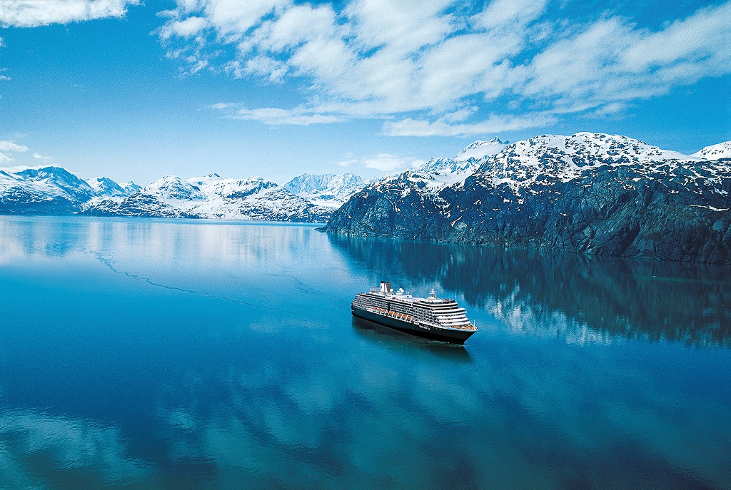 Holland America Westerdam seen cruising in Glacier Bay, Alaska with glaciers along the shore.