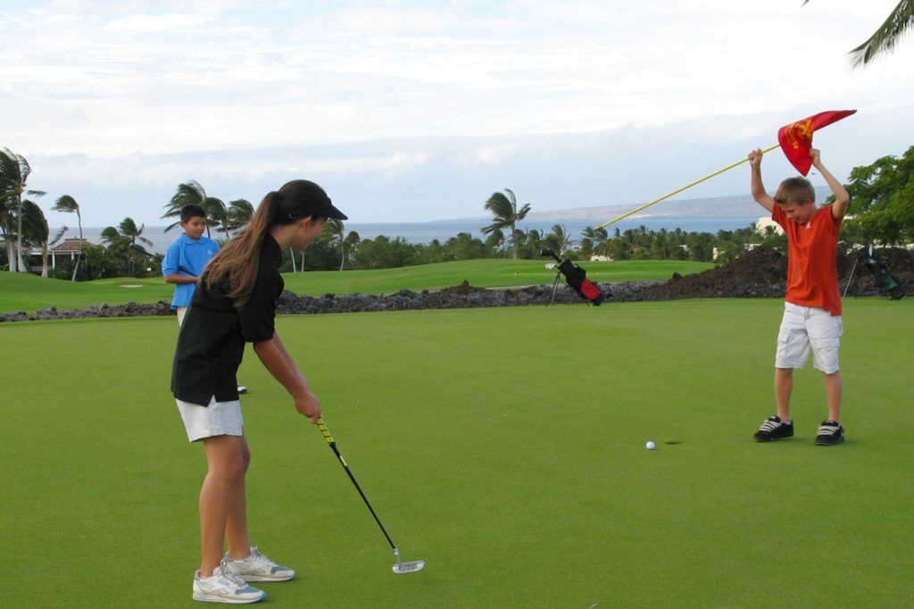 Kids playing golf at Hawaii's Mauna Lani, a top family golf resort on the Big Island. Photo c. Mauna Lani Resort