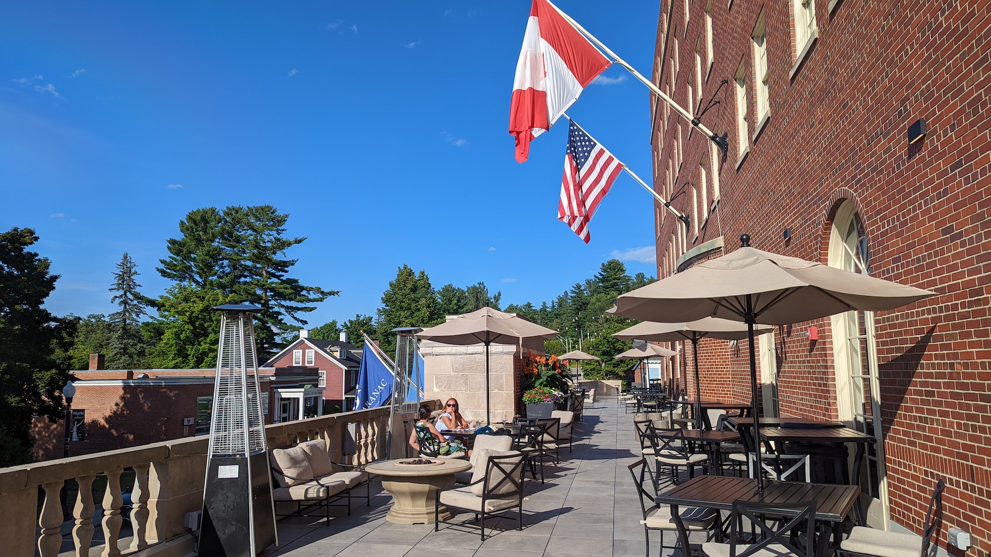 Women sit outside on the balcony of the Hotel Saranac and enjoy drinks from the bar.