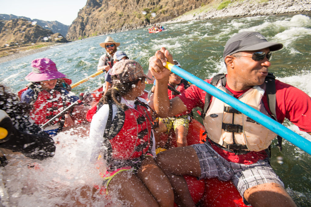 People paddling a whitewater raft on the Salmon River of Idaho.