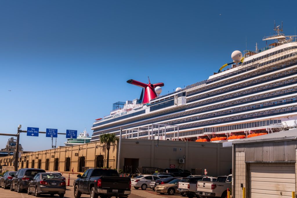 Carnival cruise ship in front of warehouses at the port of Galveston, Texas.