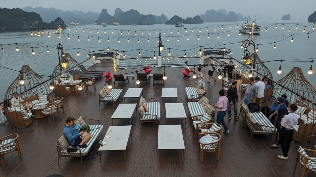 Passengers relax on the top sundeck of Ambassador Cruise I and order drinks at Happy Hour.