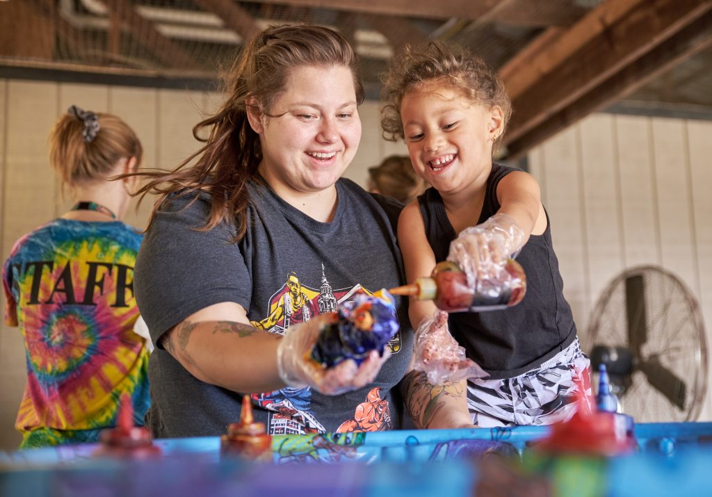 Family enjoys tie-dying crafts workshop at the Whispering Hills Jellystone Park in Big Prairie, Ohio