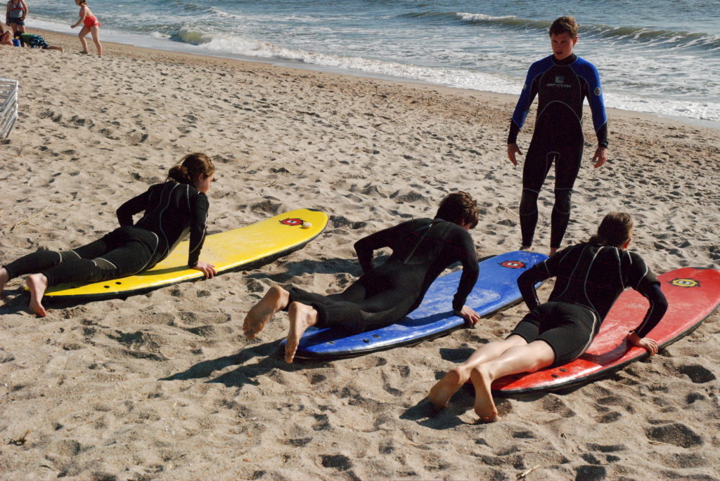 Ritz Carlton Amelia Island coach helps novice surfers get up on the waves.
