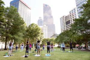 People enjoying a free yoga class at Woodruff Park in Atlanta.