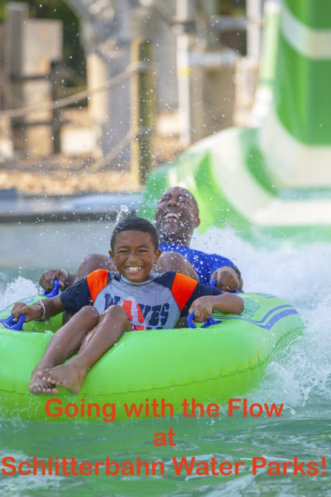 Man and boy share a double float at the Schlitterbahn Water park in Galveston Texas.