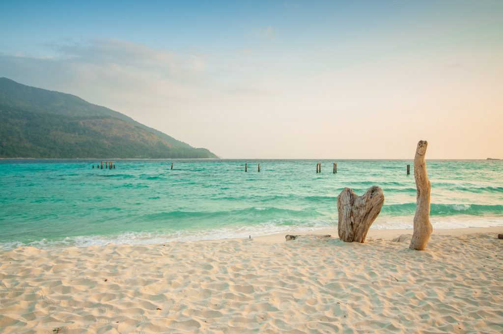 View off the coast of Thailand to vivide green water and mountains.