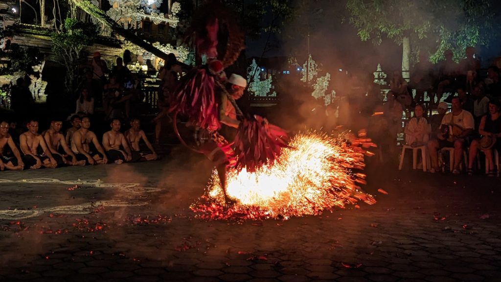 Dancer in a trance stomps on hot charcoal during the finale of a Kecak dance performance on island of Bali.