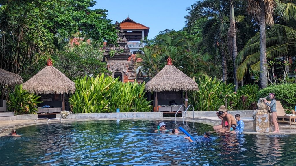 One of the pools at the Bali Beach Garden Resort in Kuta Beach, Bali. It's a favorite for multigenerational families doing Bali with kids because of its lush gardens.