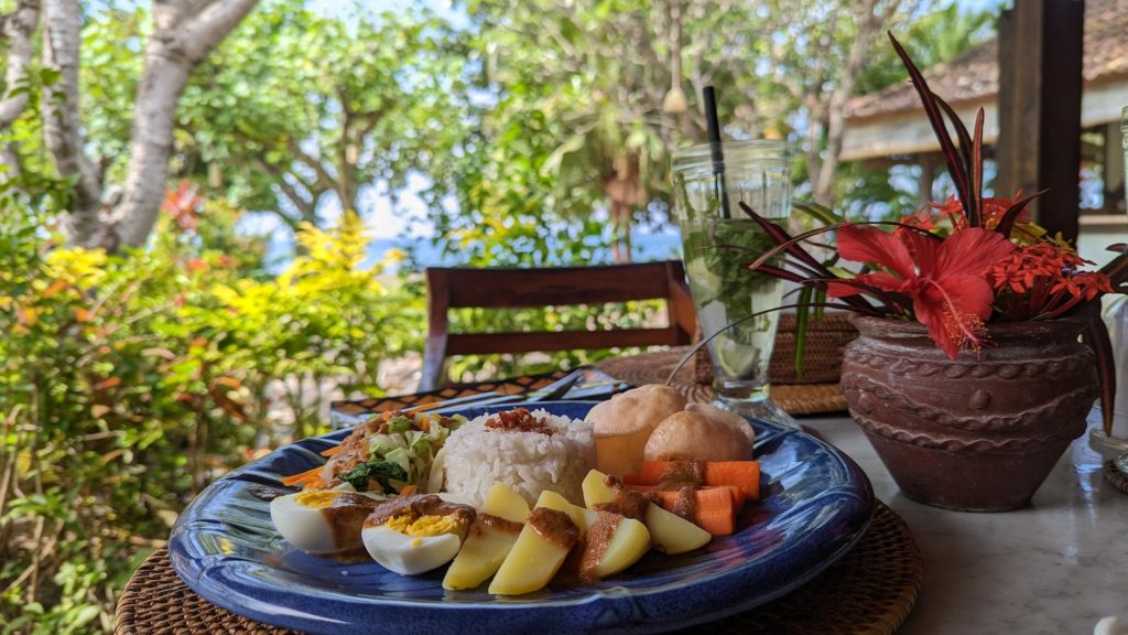 A traditional Bali gado-gado salad includes eggs, potatoes, salad, rice and chicken skewers served with a peanut sauce.