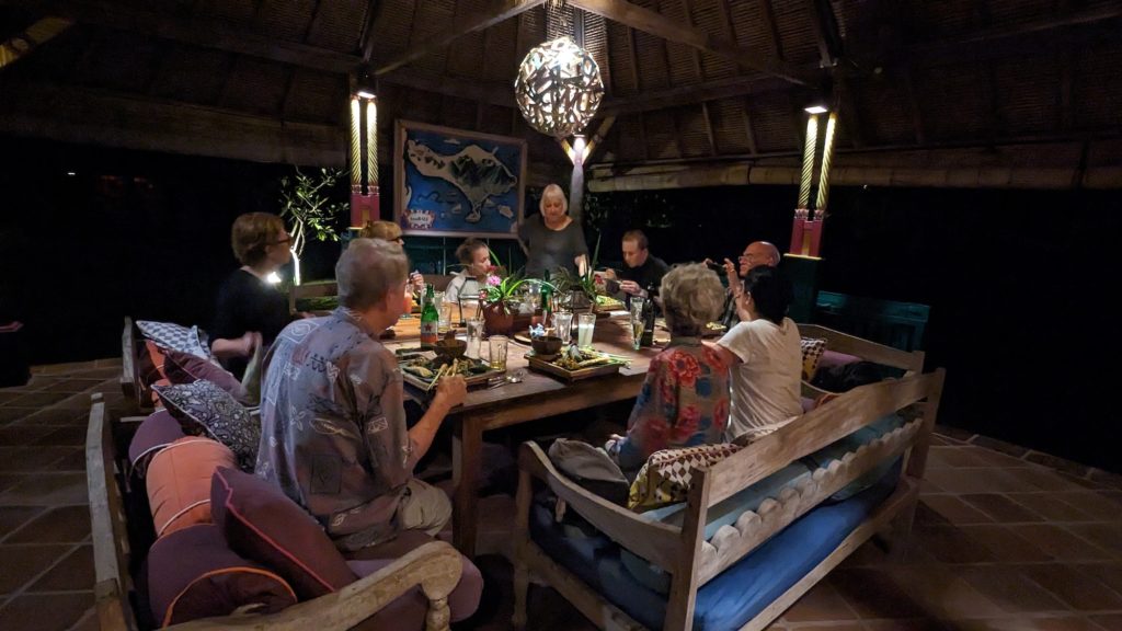 Guests enjoy a Balinese Feast at Umri Kitchen, a vegan restaurant at Permuteran Beach, Bali.