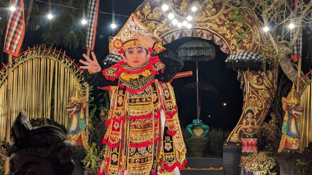 Young male dancer plays a hero character from the Ramayana legend in a classical Balinese culture performance showcasing dance and music.