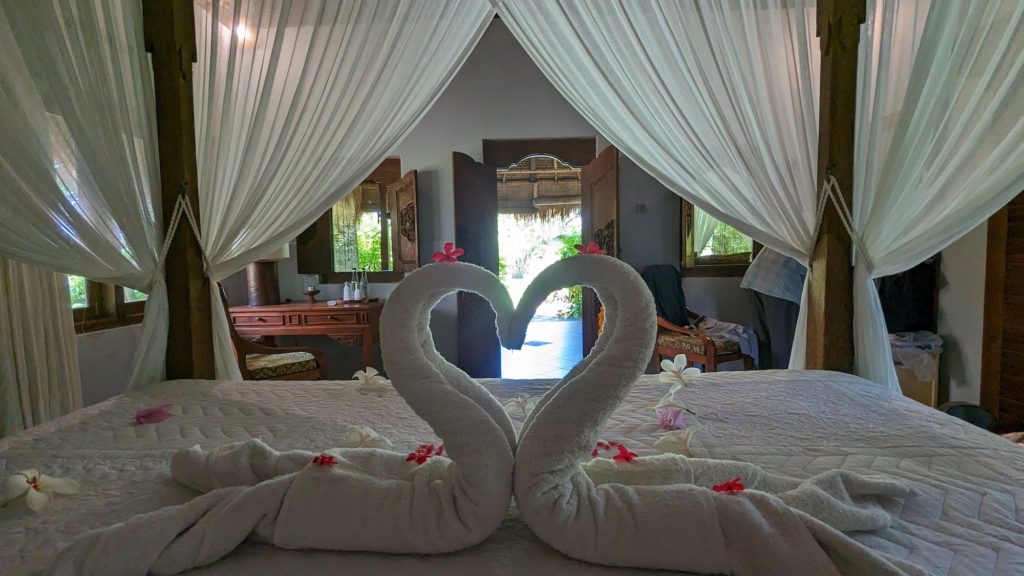 Interior of Taman Selini guest bungalow made up for honeymooners who visit Permuteran Beach to scuba dive.