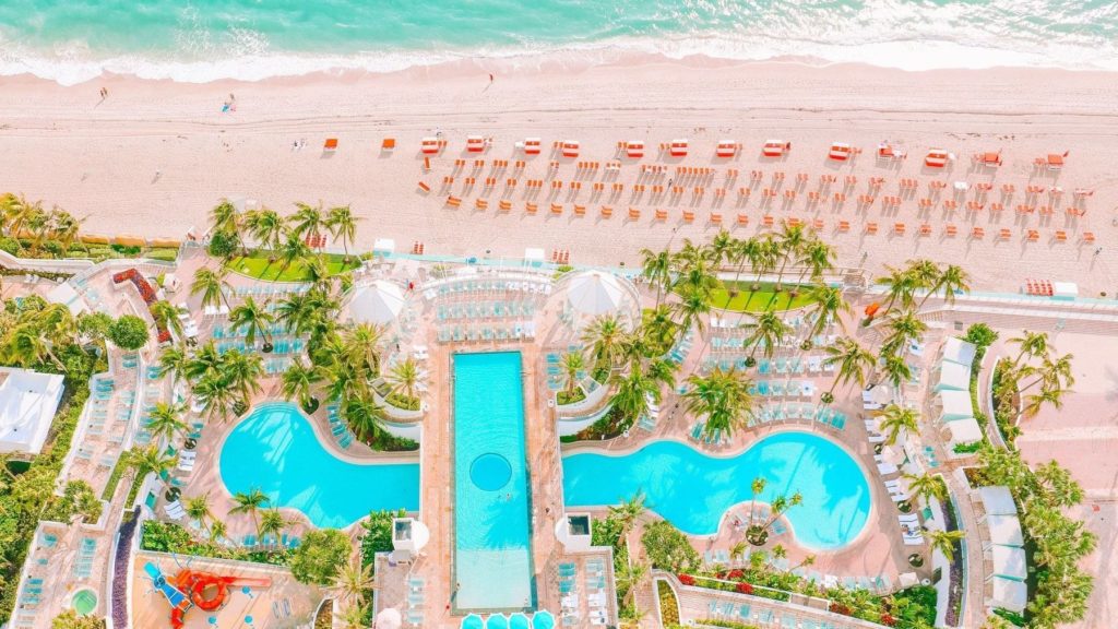 An aerial view of the two large pools, waterfront cafe and beach zone at The Diplomat Resort in Hollywood, Florida. Photo. c. The Diplomat Hotel.